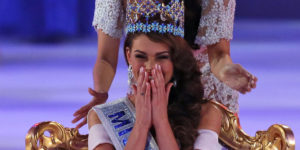 Miss South Africa Rolene Strauss laughs as she is crowned Miss World 2014 by last year's winner Megan Young, during the finale of the competition at the ExCel centre in London, Sunday, Dec. 14 2014. Miss Hungary Edina Kulcsar  came second with Miss United States, Elizabeth Safrit finishing third. (AP Photo/Alastair Grant)